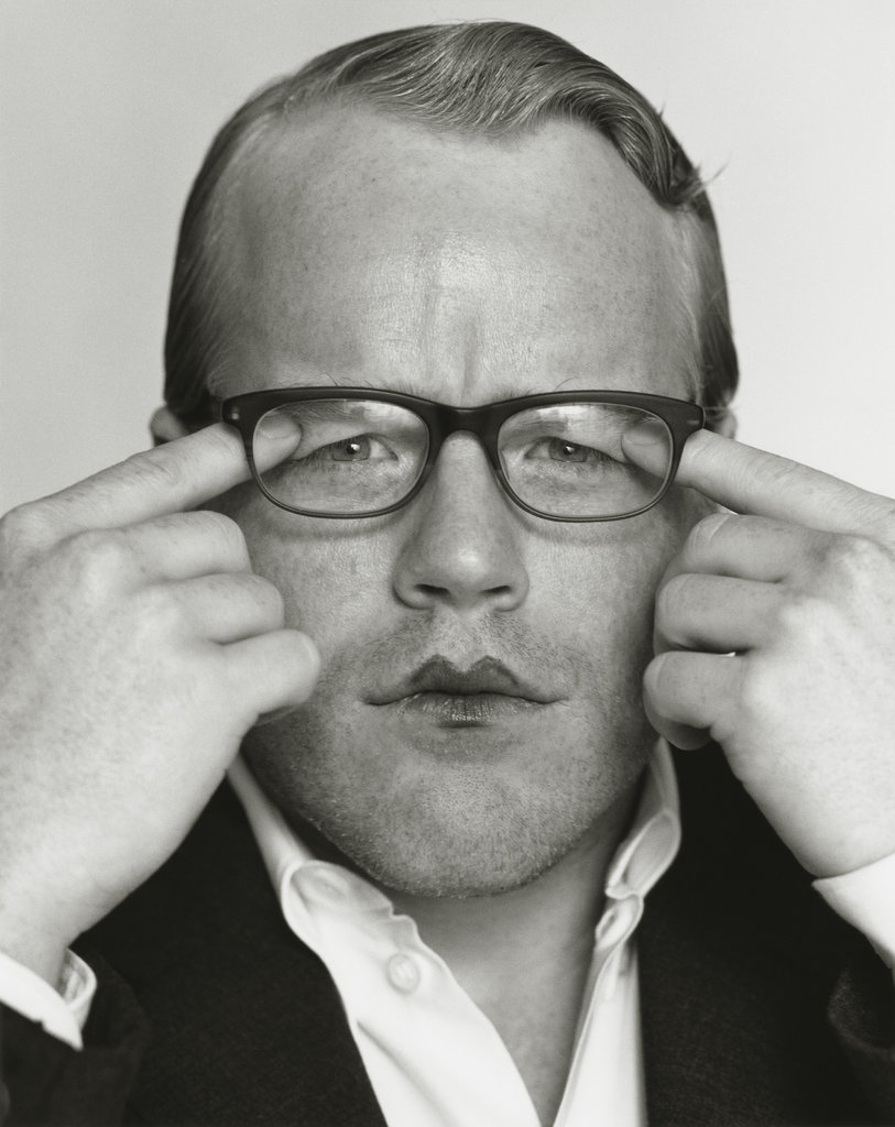 A young Philip Seymour Hoffman pulls eyelids down under his glasses