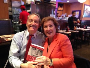 Woman in orange blazer holding Cleft Heart with author.