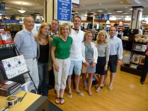 Author and half a dozen or more fans posing in bookstore.