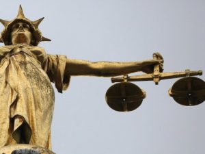 Statue  with Scales of justice for Ending white privilege in crime?