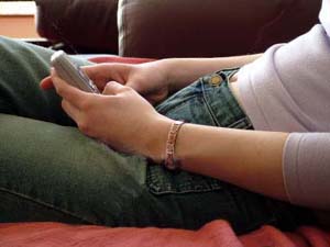 Girl slouching, looking at cellphone