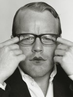 A young Philip Seymour Hoffman pulls eyelids down under his glasses
