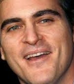 Smiling man with scar running from upper lip to his left nostril