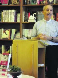 Karl Schonborn, standing at podium, talking at bookstore event.