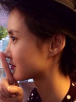 Asian woman puts finger from chin to tip of nose.