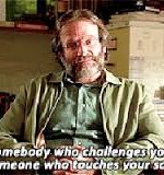 Comedian and actor Robin Williams seated.