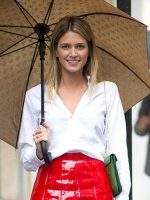 Nice figured, smiling, healthy haired woman wearing red. holding umbrella.