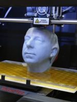 White head in middle of box-like 3d-printer for cleft lip & palate surgery