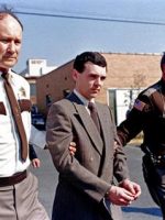 Angel of Death serial killer Harvey. MS of handcuffed man with 2 guards.