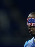 Black man with blindfold in red-white-and-blue, like a flag.