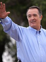 Male privilege in action? Rep Franks in blue shirt, waving. Scar from cleft on upper lip.